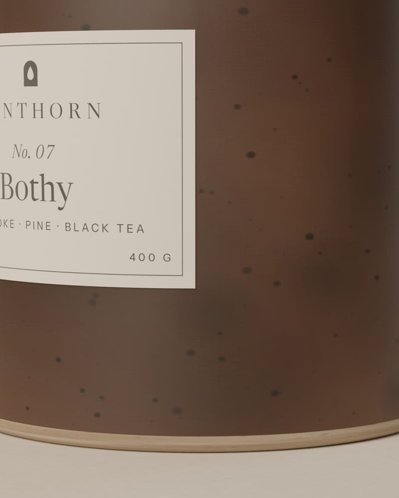 Close view of the iron-brown peat glaze on the Bothy vessel, with dark speckles and a raw stoneware foot.